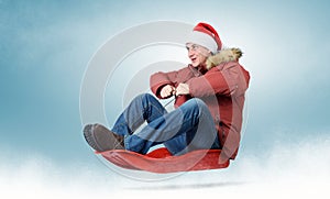 Man in red cap Santa Claus on a sledge