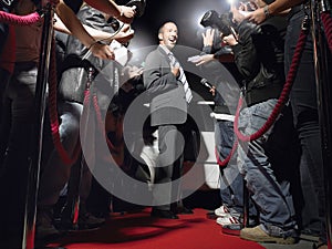 Man On Red Carpet Posing In Front Of Paparazzi
