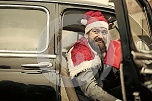Man in red hat deliver xmas gifts in retro car