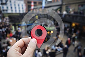 Man with a red marker in Candem Market, London, UK