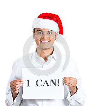 man in red santa claus hat holding a I CAN ! sign