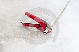 Man with red scissors cut pipes for heating, or water. polypropylene mounting system