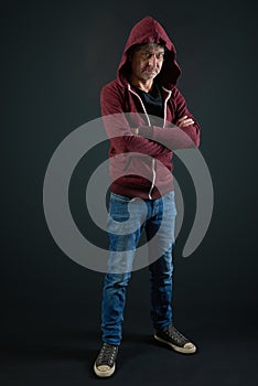 Man with red shirt and denim pant on gradient background