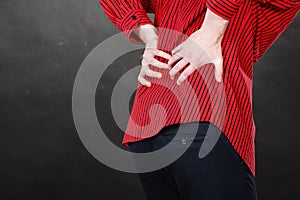 Man in red shirt having back pain