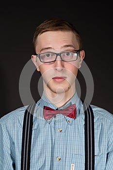 Man in a red suit and a bow tie plaid shirt on a black background