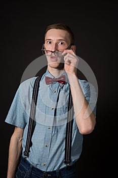 Man in a red suit and a bow tie plaid shirt on a black background