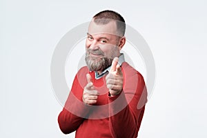 Man in red sweater pointing his finger at you