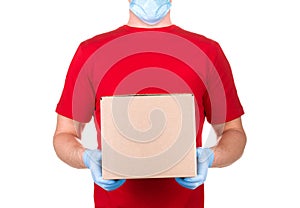 Man in red t-shirt and blue medical glove holding cardboard box isolated white