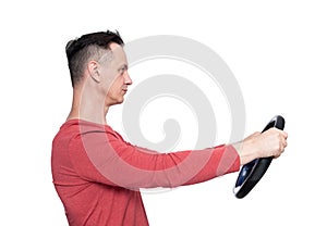 Man in red t-shirt with a steering wheel, side view, isolated on white background. Car drive concept