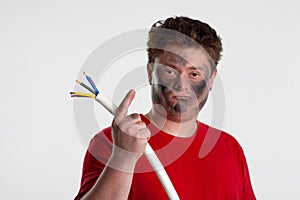 A man in a red T-shirt warns against repairing electrical appliances on his own photo
