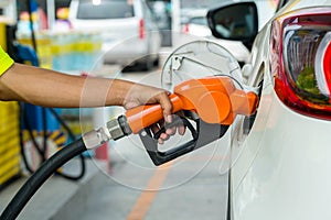 Man Refill and filling Oil Gas Fuel at station.Gas station - refueling.To fill the machine with fuel. Car fill with gasoline at a