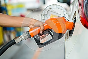 Man Refill and filling Oil Gas Fuel at station.Gas station - refueling.To fill the machine with fuel. Car fill with gasoline at a