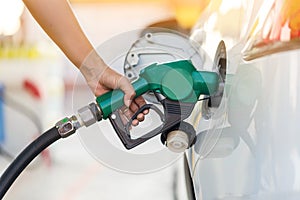 Man Refill and filling Oil Gas Fuel at station.Gas station - refueling.To fill the machine with fuel. Car fill with gasoline at a