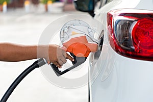 Man Refill and filling Oil Gas Fuel at station.Gas station - refueling.To fill the machine with fuel. Car fill with gasoline at a