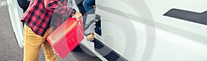 Man refueling his camper van with a jerrycan