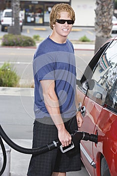 Man Refueling His Car At Service Station