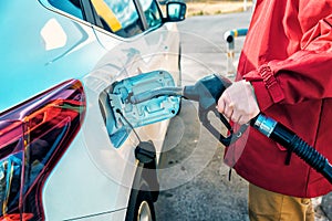 Man refueling tank a car