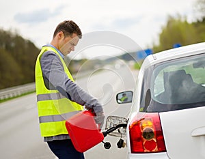 Man refuelling car on a roadside