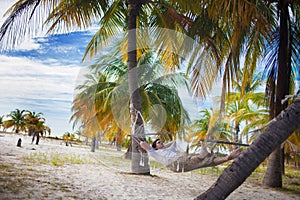 Man relax on the beach in hammock