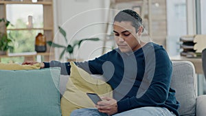 Man, relax on couch and smartphone, social media scroll and communication, tech and internet. Connectivity, using phone