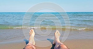 Man in relax stay with his feet on tropical caribbean beach sea with gold sand, holiday, relax and travel