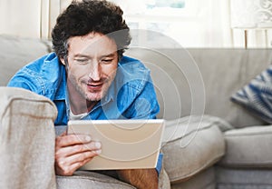 Man, relax and tablet internet on sofa for digital contact, social media or movie app. Male person, streaming film and