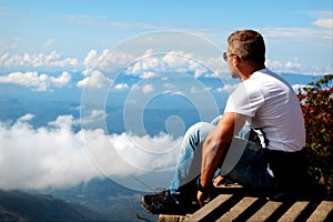 Man relaxes on the edge of the cliff . Plateau ` End of the World ` , Sri Lanka photo