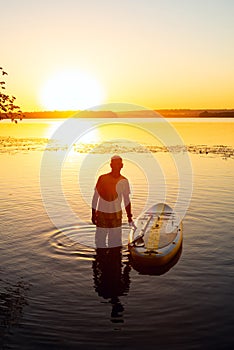 Man relaxes after paddling on a SUP board