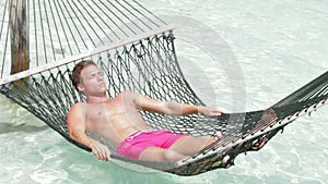 Man Relaxing In Beach Hammock