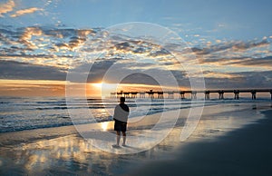 Man relaxing on the beautiful beach at sunrise.