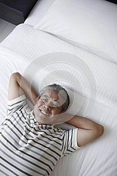 Man relaxing in bed. Conceptual image