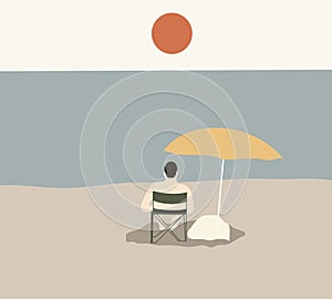 Man relaxing on chair at sandy beach under yellow umbrella.