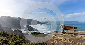 Man relaxing and enjoying the vie at the cliffs of Loiba in Galicia photo