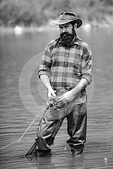 Man relaxing and fishing by lakeside. Weekends made for fishing. Fisher masculine hobby. Master baiter. Keep calm and