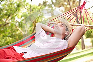 Man Relaxing In Hammock