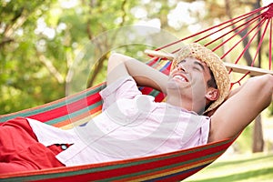 Man Relaxing In Hammock