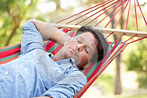 Man Relaxing In Hammock