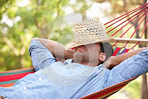 Man Relaxing In Hammock