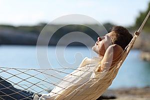 Man relaxing on a hammock in the beach