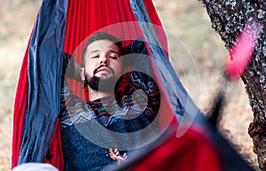 Man relaxing in a hammock on a picnic