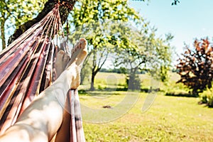 Man relaxing in the hammock on a sunny day