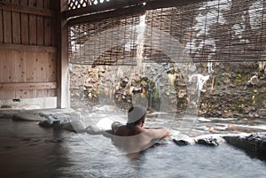 Man relaxing in Japanese onsen photo