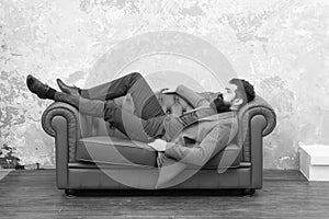 Man relaxing on luxurious leather couch, feeling comfortable concept