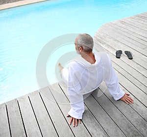 Man relaxing near swimming pool