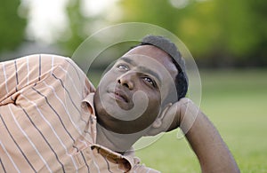 Man relaxing outdoors looking happy and smiling