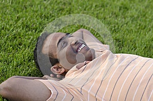 Man relaxing outdoors looking happy and smiling