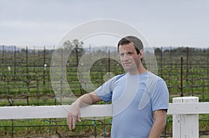 Man relaxing outside in a vineyard. Hopeful for tomorrow.