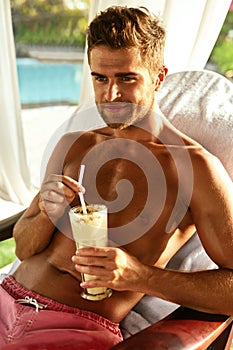 Man Relaxing At Spa With Cocktail Drink On Summer Vacations