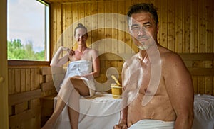 Man relaxing and sweating in hot sauna