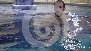 Man relaxing in swimming pool